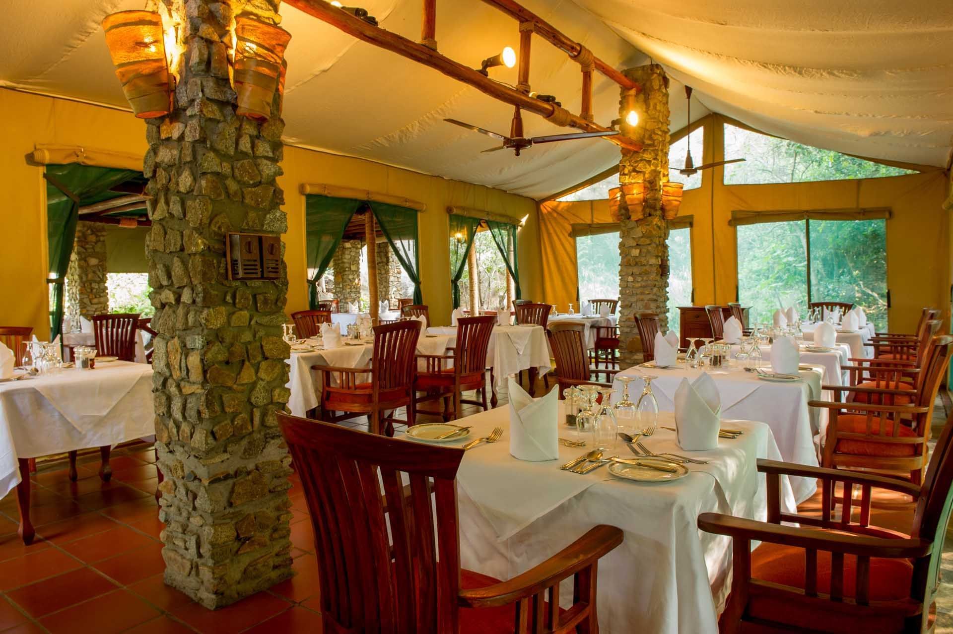 Dining area with arranged tables at Mbuzi Mawe Serena Camp