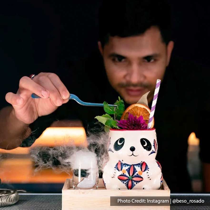A talented bartender was decorating cocktails in Beso Rosado - Lexis Suites Penang