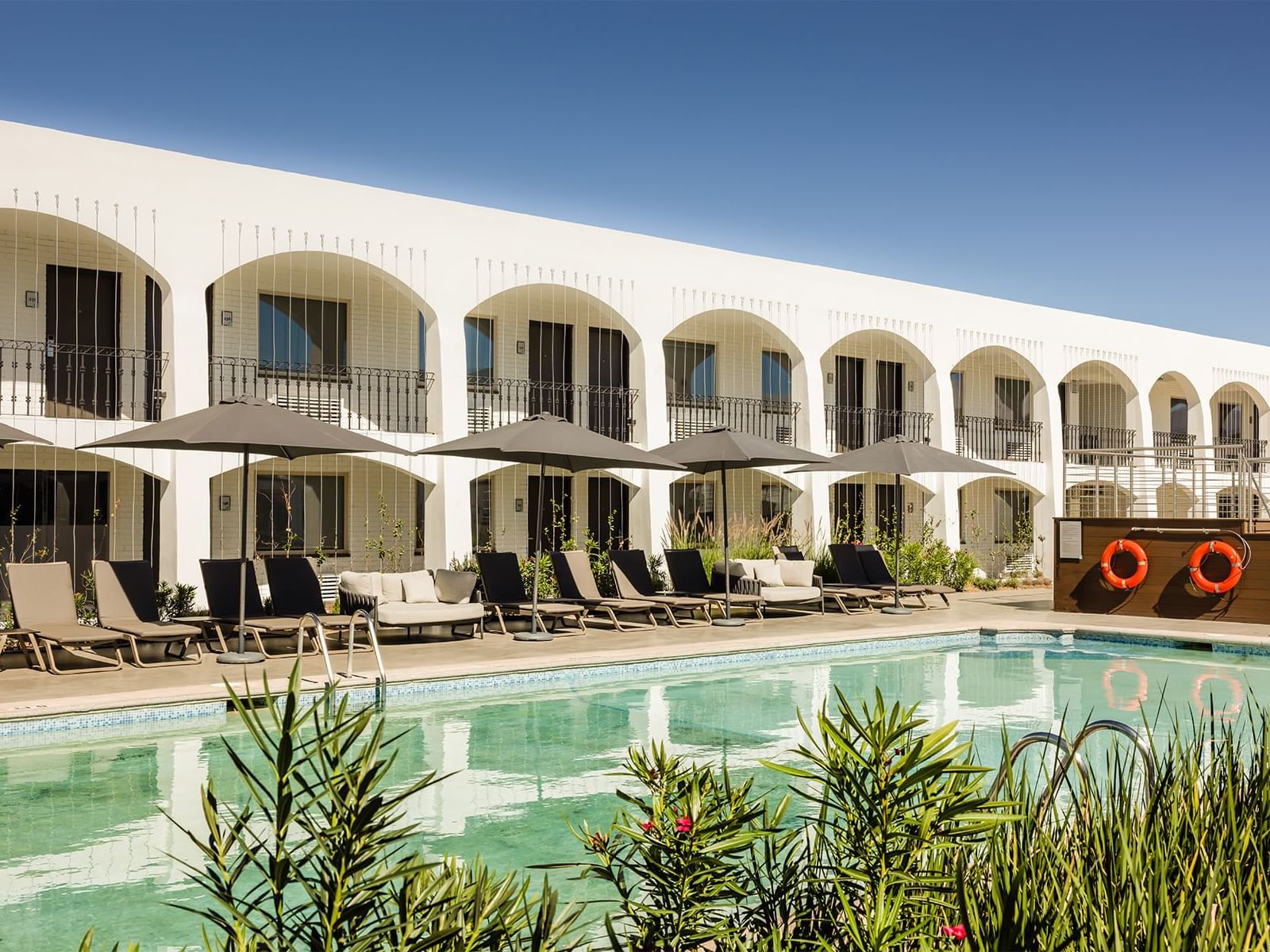 Sunbeds by the outdoor pool at Fiesta Americana Travelty