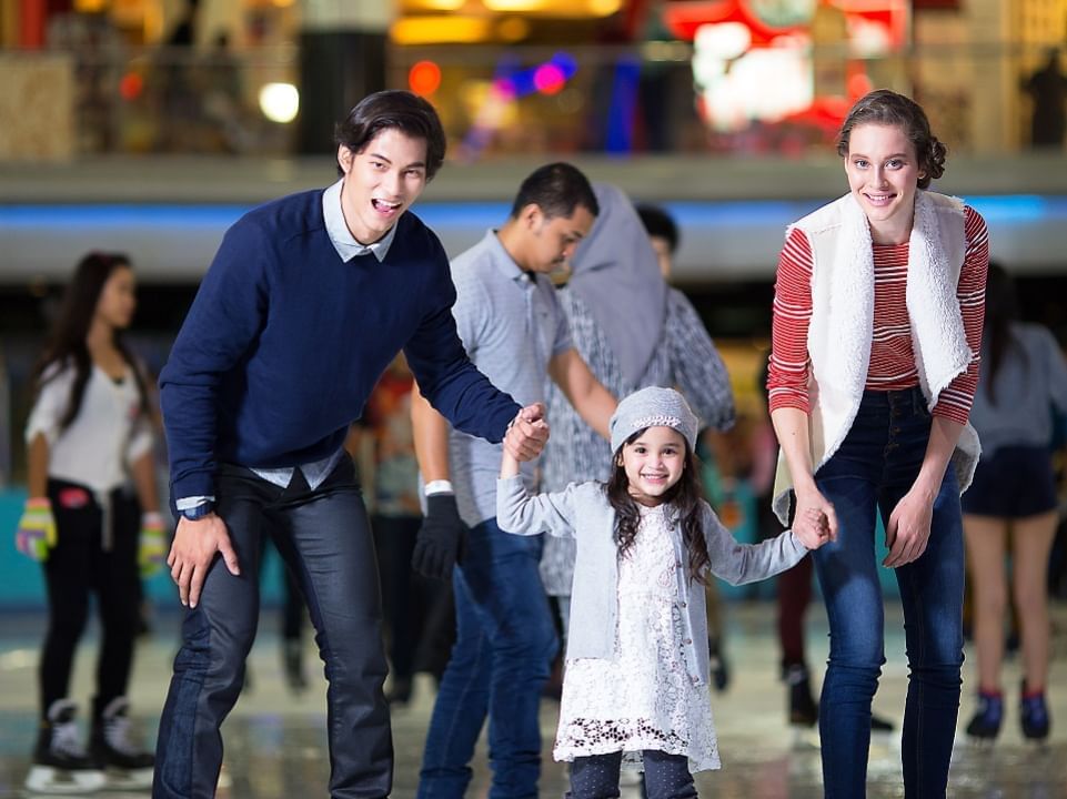 Family posing to a picture while ice skating near Sunway Lagoon