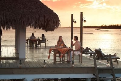 A couple having champagne at deck restaurant of Club Hemingway