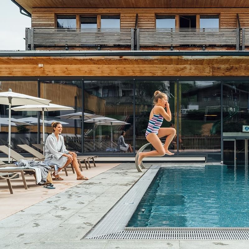 Mom & daughter by the pool at Falkensteiner Hotel Sonnenalpe
