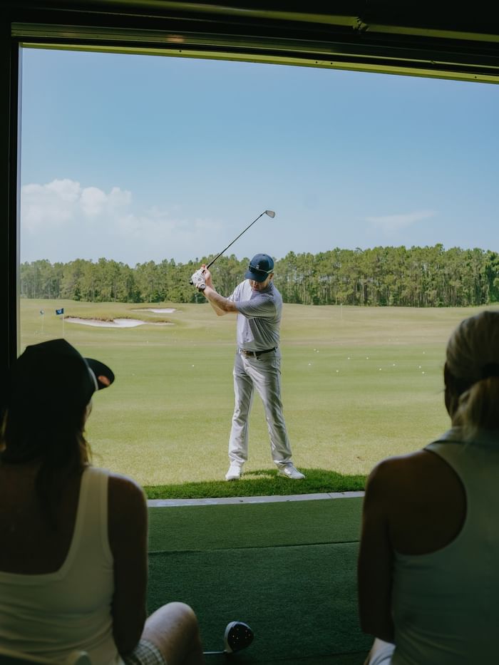 Golf instructor at Camp Creek Golf Performance Center with spectators from Watersound Inn, Inlet Beach.