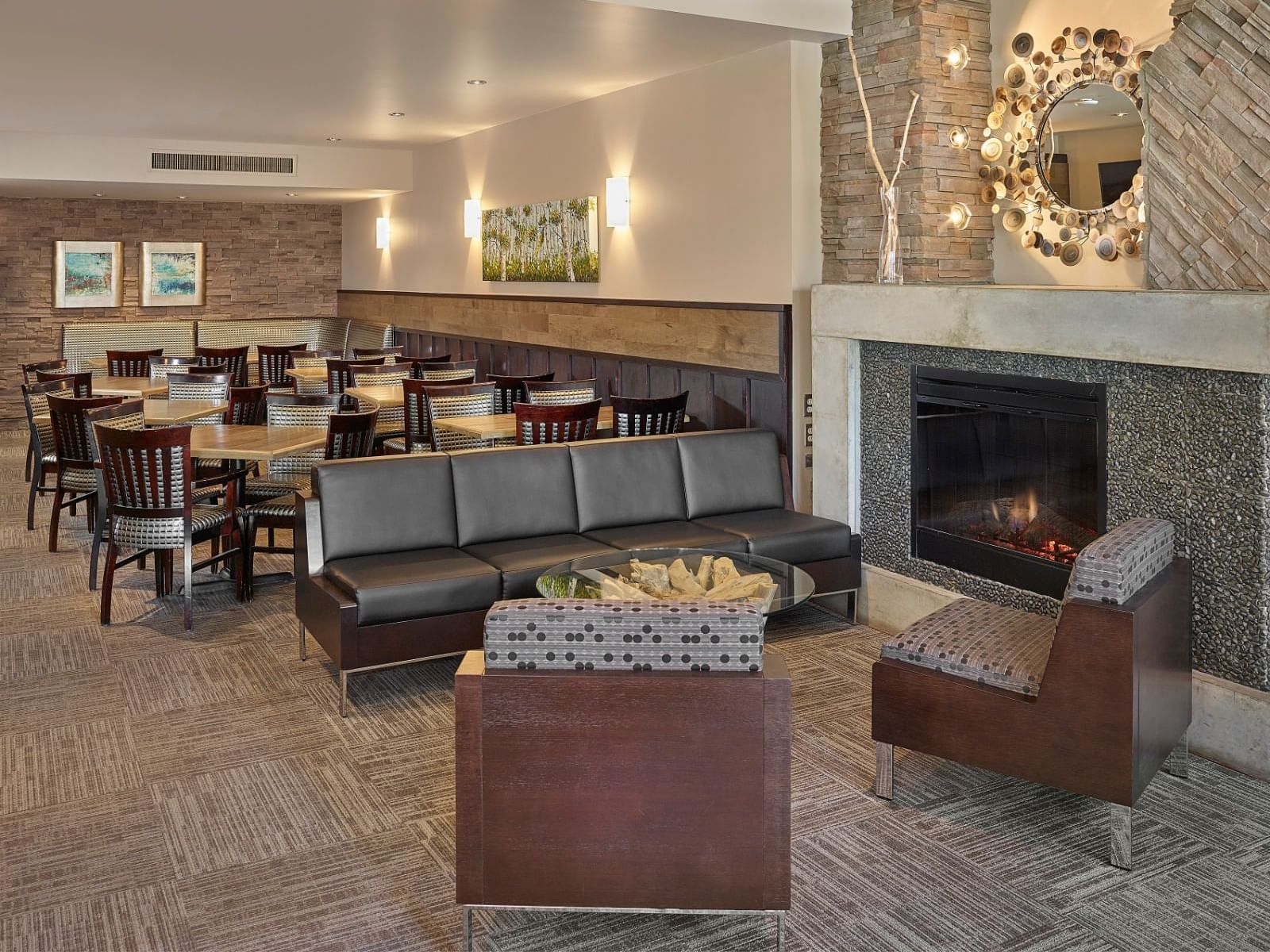 Sofa near fireplace in the hotel lounge & dining set-up at Varscona Hotel on Whyte