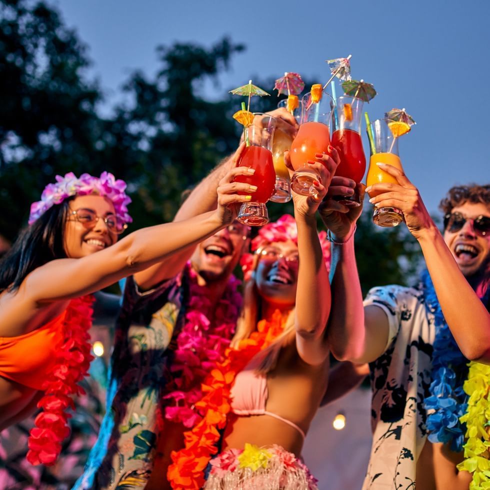 People toasting with tropical drinks at Falkensteiner Family Hotel Diadora