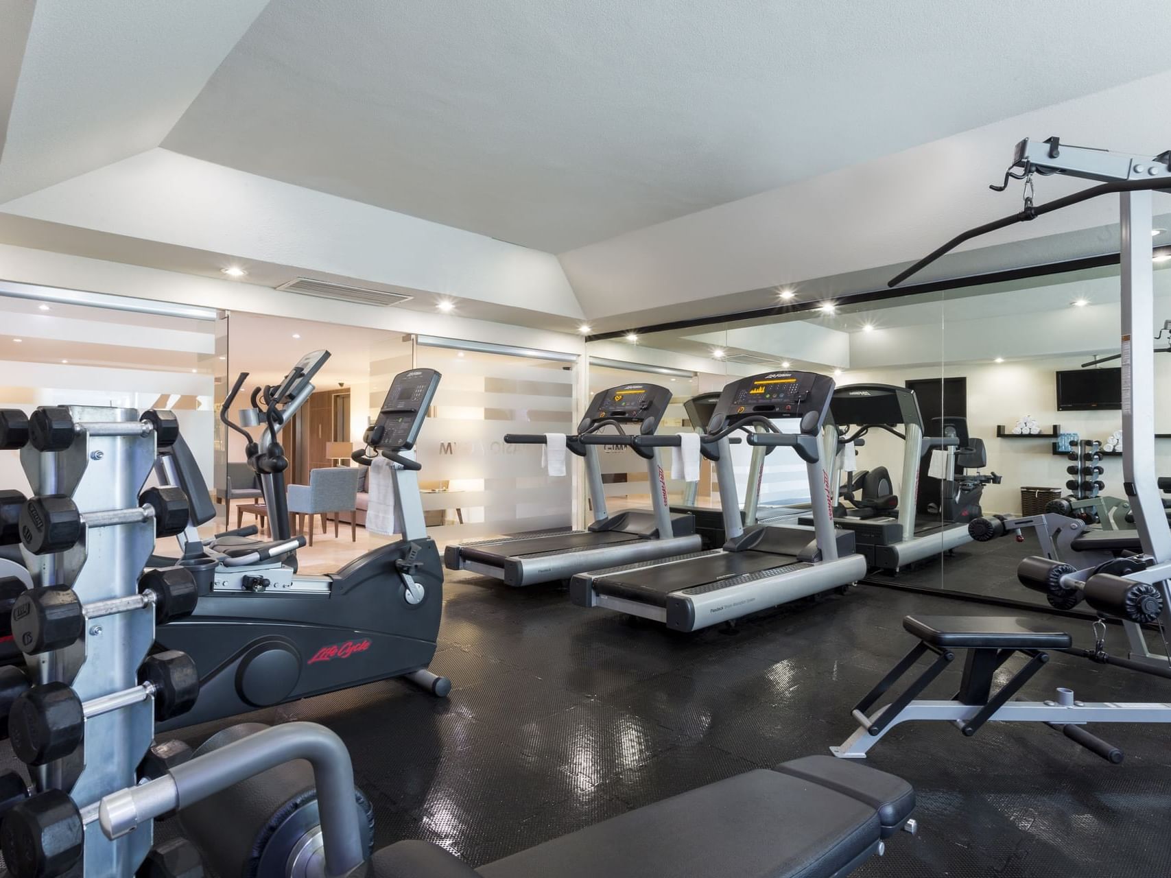 Interior of the gym with fitness machines at Gamma Hotels