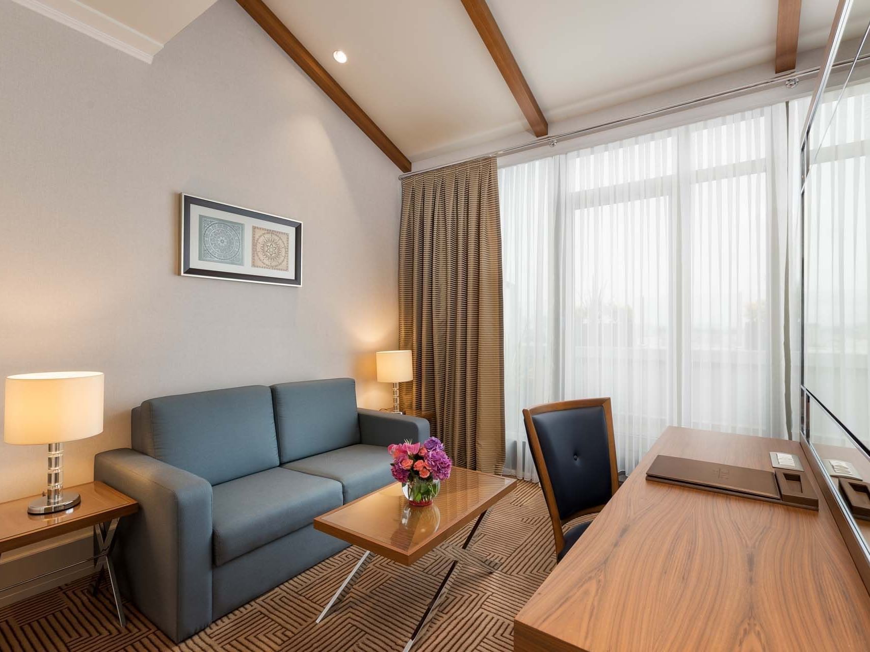 Lobby area with comfy sofa and TV in Executive Room at Titanic City Taksim