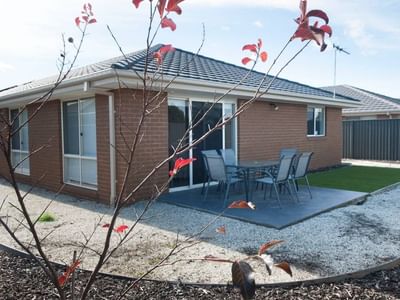 Modern house with patio and outdoor dining area at La Trobe University Regional Housing – Shepparton.