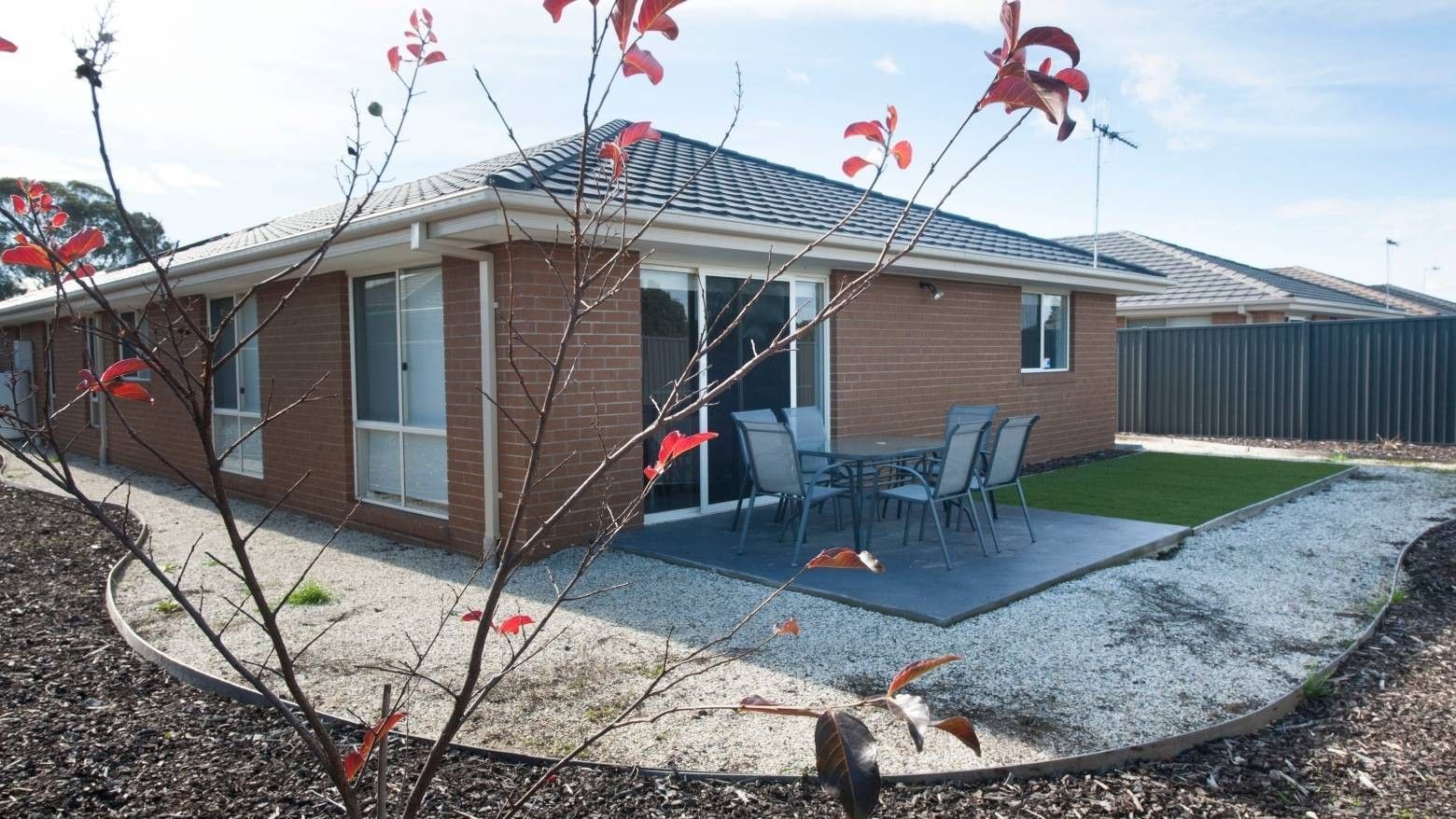 Modern house with patio and outdoor dining area at La Trobe University Regional Housing – Shepparton.