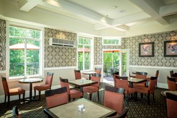 Arranged dining tables in the Garden Room of Plaza Inn & Suites at Ashland Creek