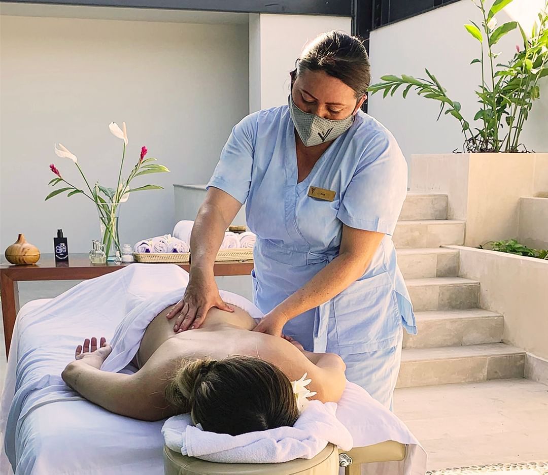 A lady receiving a back massage in the spa at Mundo Imperial