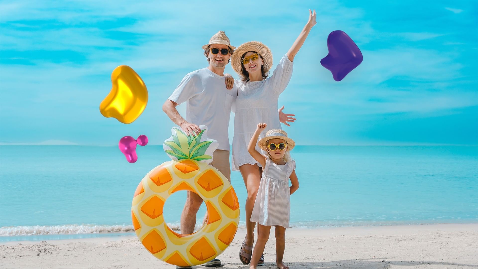 Family with pineapple float by the shore under a blue sky, surrounding the beach at Quinta Real Huatulco