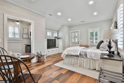 Deluxe King Cottage with plush bed, wooden floors, dining table, and TV, by Cottages at Laurel Brooke