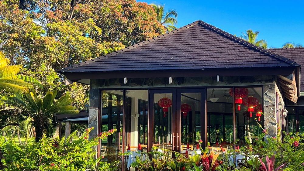 Bamboo Terrace restaurant with outdoor seating and lush greenery at The Naviti Resort in Korolevu.