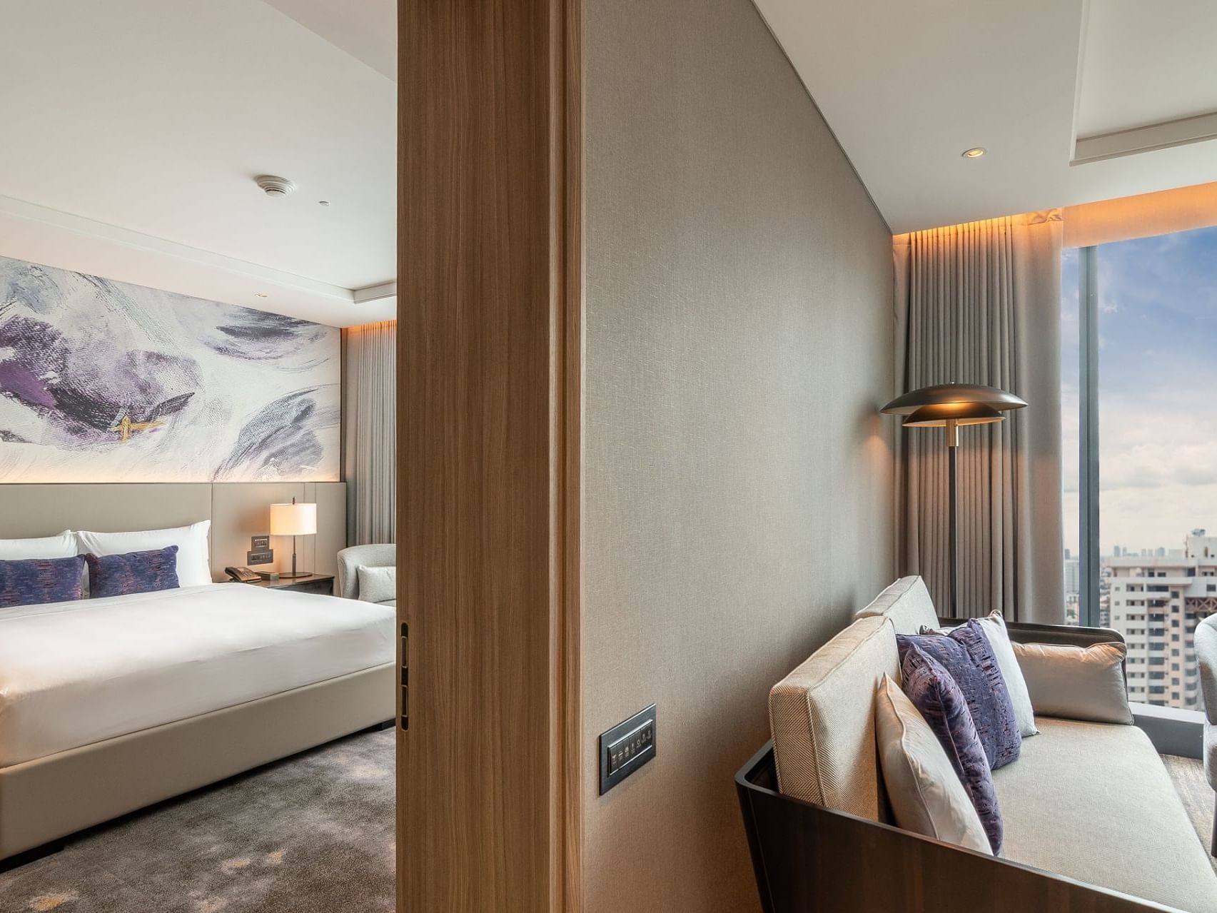Bed & living in Executive Suite at Carlton Bangkok Sukhumvit