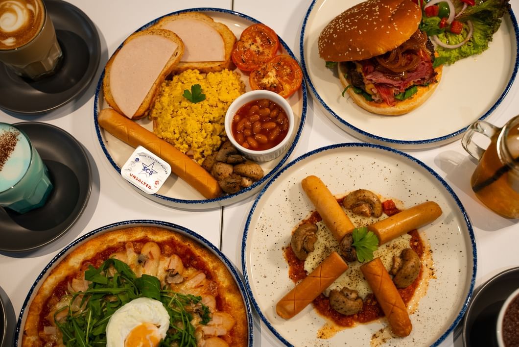 A delightful table set with various plates of food and drinks in Sunway Boulevard 88 at Sunway Hotel Big Box