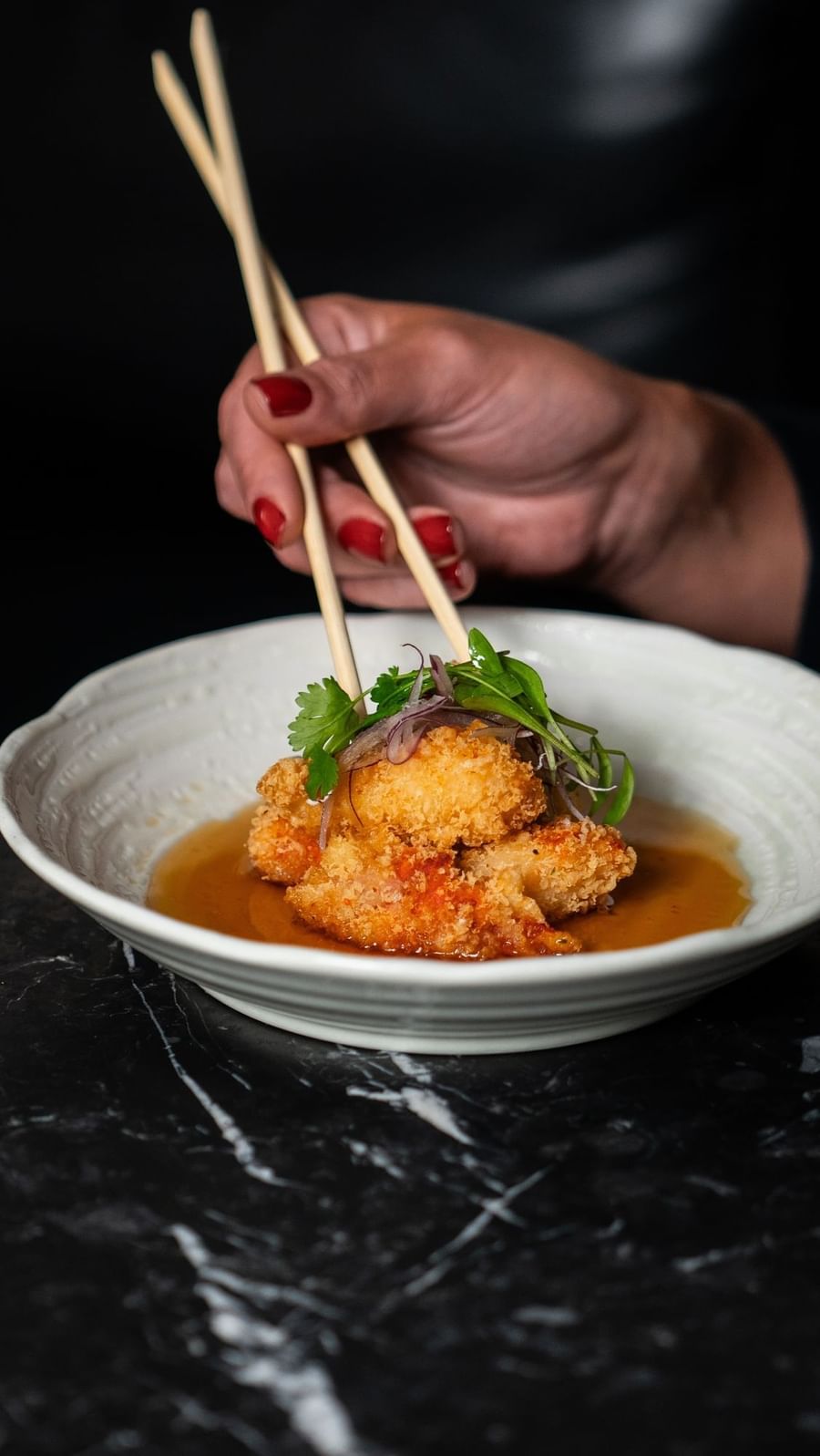 Close-up of a meal with fried fish and chopsticks in Japanese Izakaya at The May Fair Hotel