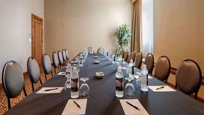 Long table with chairs in conference room