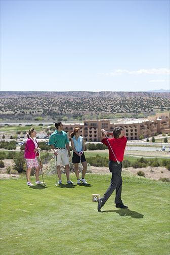 Golfers at a Towa Golf Club course near Hilton Santa Fe Buffalo Thunder, with one man swinging his club