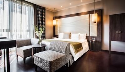 King Bed & furniture in a room
at Uptown Palace in Milan