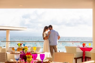 Couple embracing on a balcony by the sea at Villa Premiere Boutique Hotel & Romantic Getaway