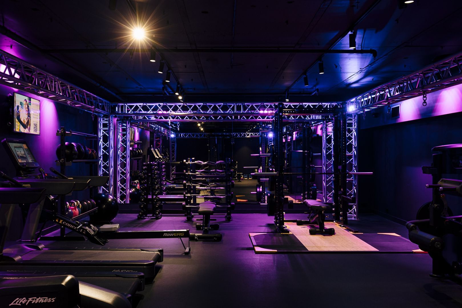 Gym interior with purple lights at Pullman Melbourne CBD