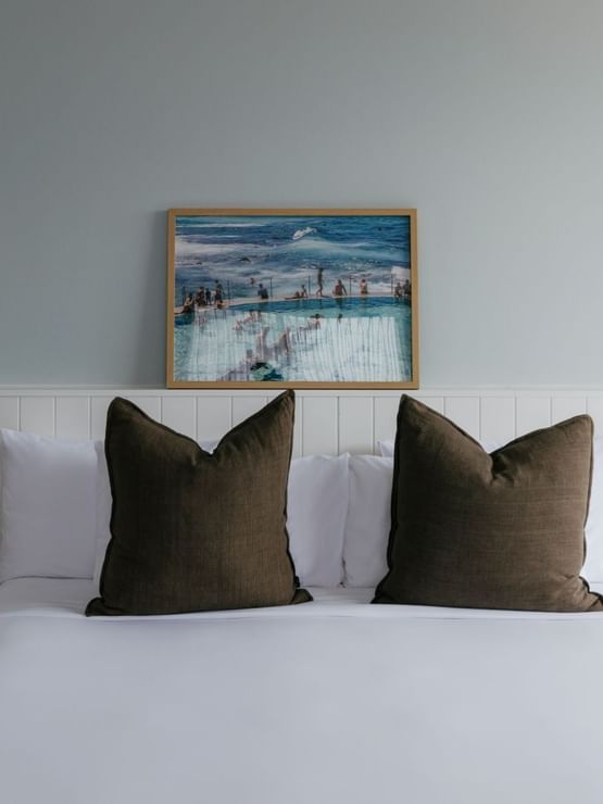 Sunset Junior Suite at Elysium Manly with olive velvet cushions by marble nightstands, a top choice for Manly accommodation