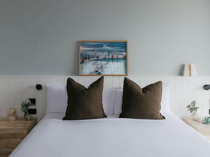 Sunset Junior Suite at Elysium Manly with olive velvet cushions by marble nightstands, a top choice for Manly accommodation