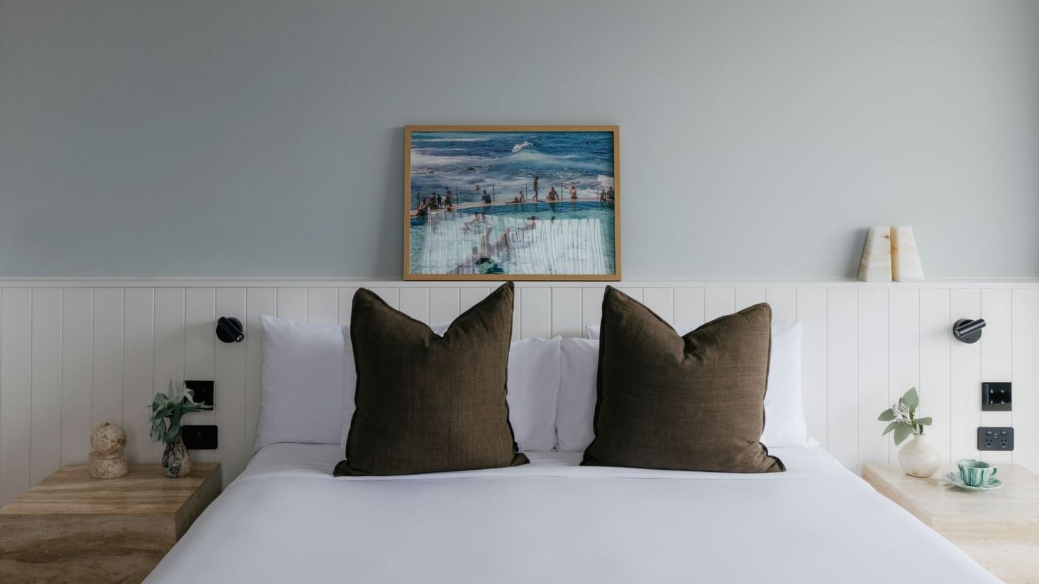 Sunset Junior Suite at Elysium Manly with olive velvet cushions by marble nightstands, a top choice for Manly accommodation