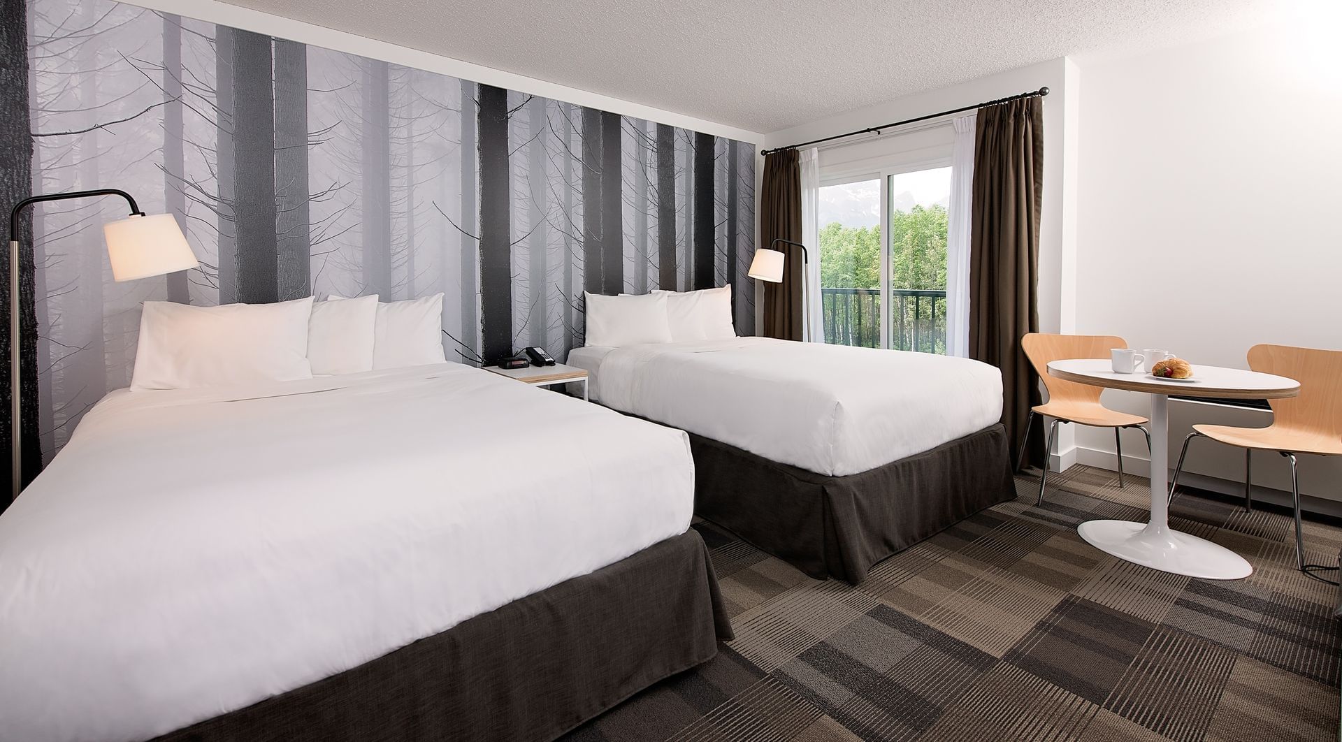 Two beds in modern hotel room with window