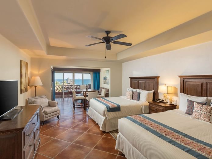 Studio 2 Queen Beds room with queen beds, wooden furniture and balcony overlooking ocean views at Hacienda Del Mar Los Cabos.