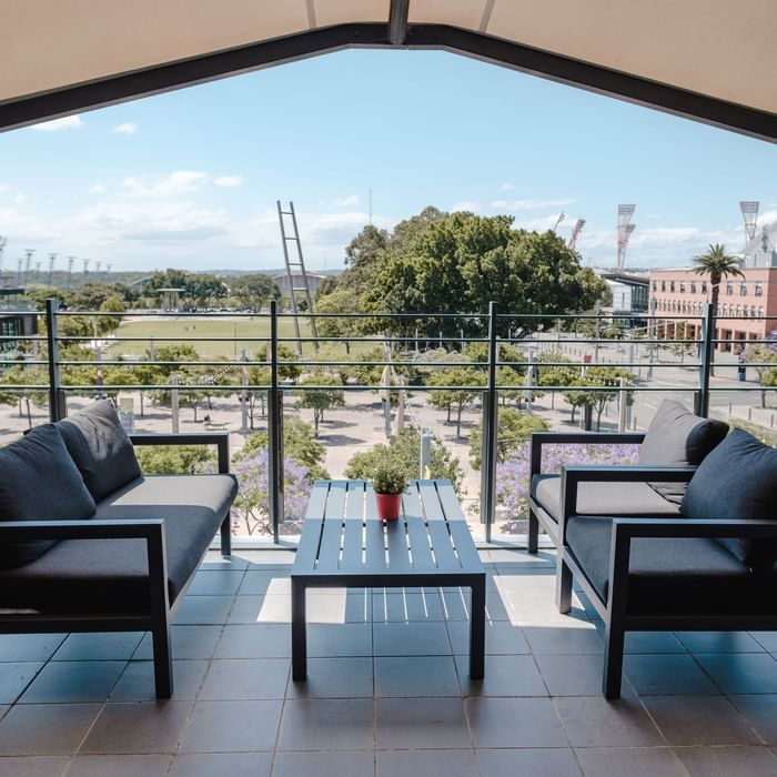 Balcony lounge area with a view at Novotel Sydney Olympic Park