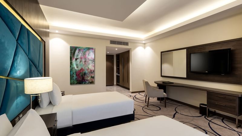 Deluxe Twin Room with cozy bed and working area at Warwick Riyadh