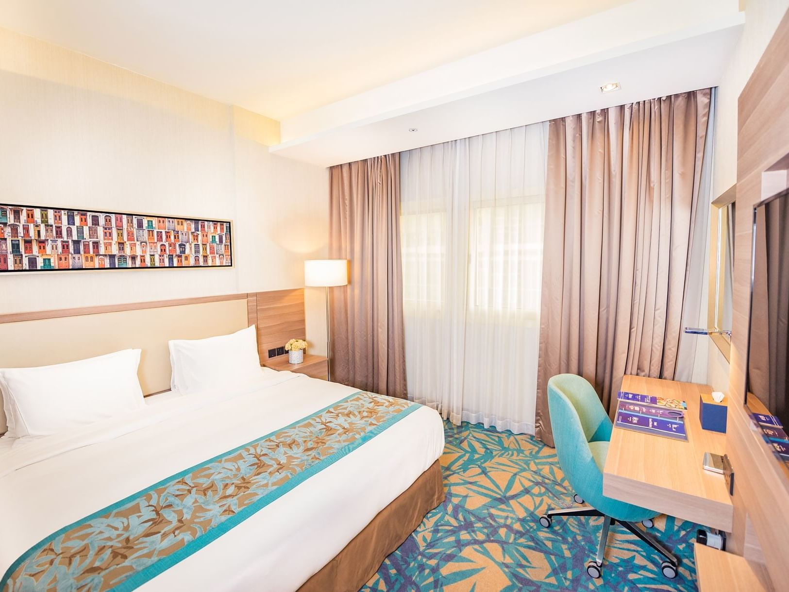 TV & king size bed in Deluxe king Suite at Mena Plaza Hotel
