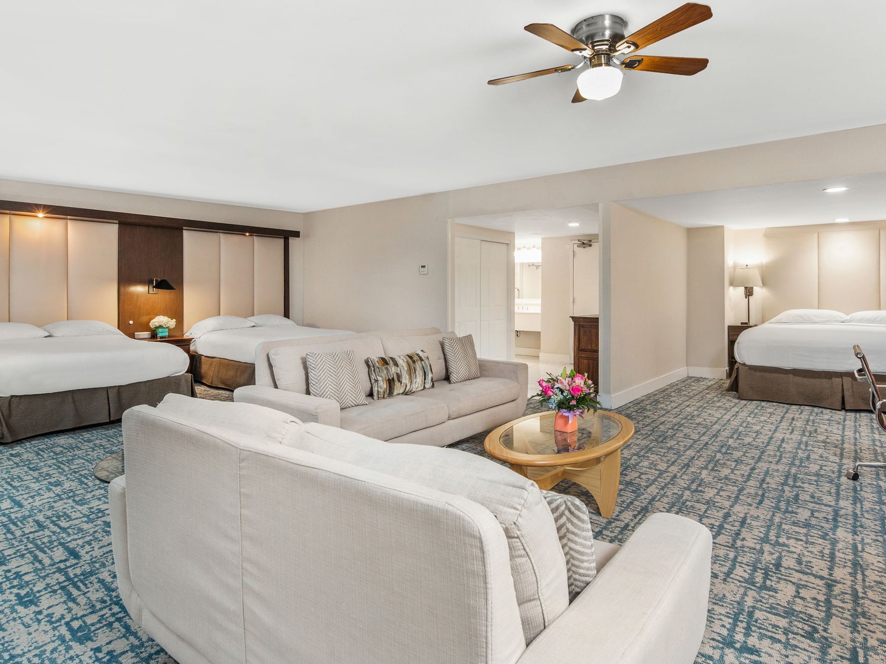 Large suite with one king bed, two queen beds, and two sofas