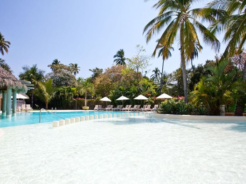 An outdoor swimming pool & sunbeds at Gamma Hotels