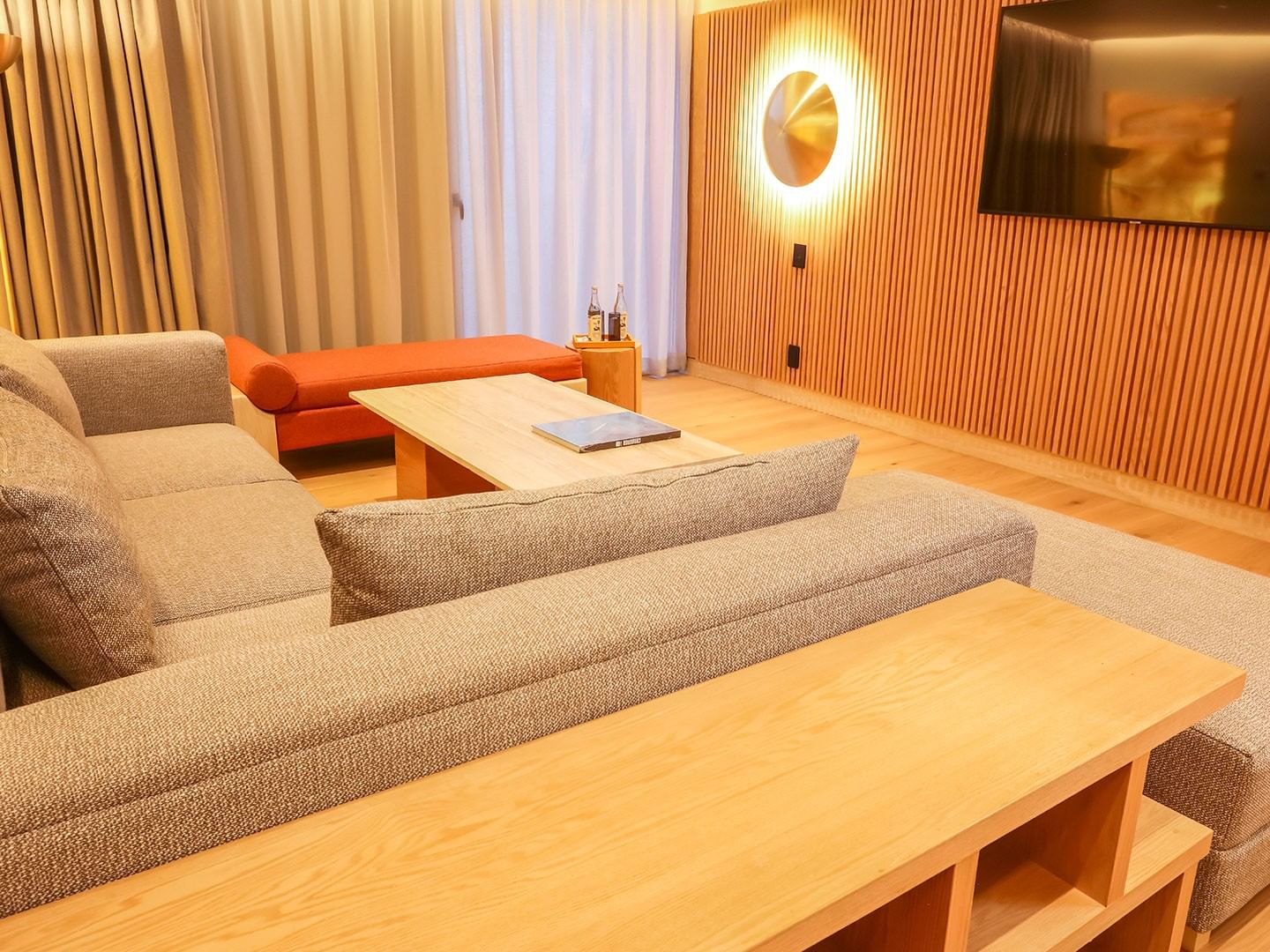 Modern living area with cozy couches and wooden tables in King Superior Junior Suite at Camino Real Polanco Mexico in Ciudad de Mexico.