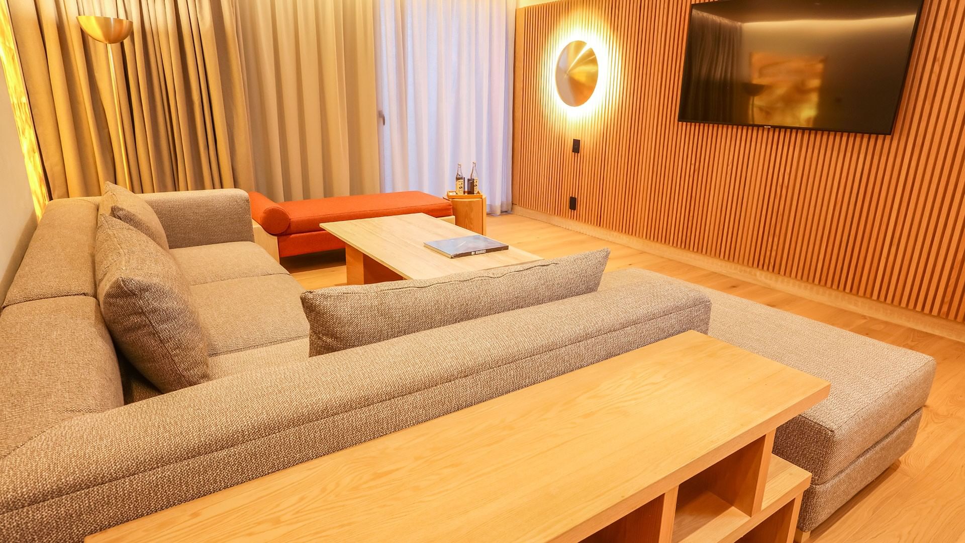 Modern living area with cozy couches and wooden tables in King Superior Junior Suite at Camino Real Polanco Mexico in Ciudad de Mexico.
