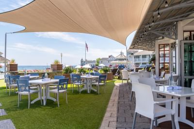 Outdoor dining area with tables and ocean views at Anchorage By The Sea