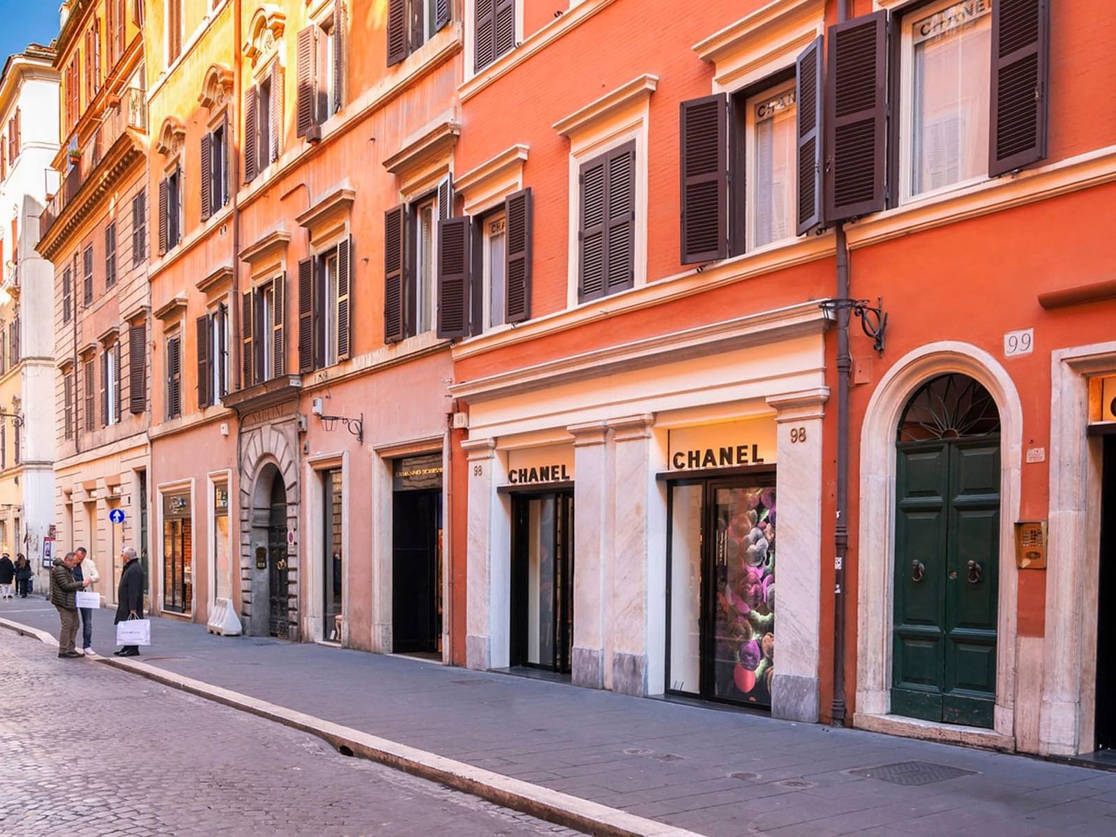 Via del Babuino in Rome with a Chanel boutique, historic architecture, and vibrant walls near The Guardian Hotel