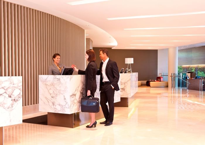 A couple with receptionist - Novotel Sydney Olympic Park