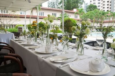 Table setup by the pool for an event at Goodwood Park Hotel