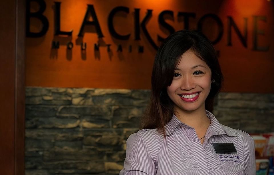 Front desk agent posing in the reception at Blackstone Mountain Lodge