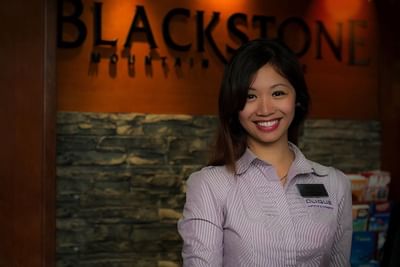 Front desk agent posing in the reception at Blackstone Mountain Lodge