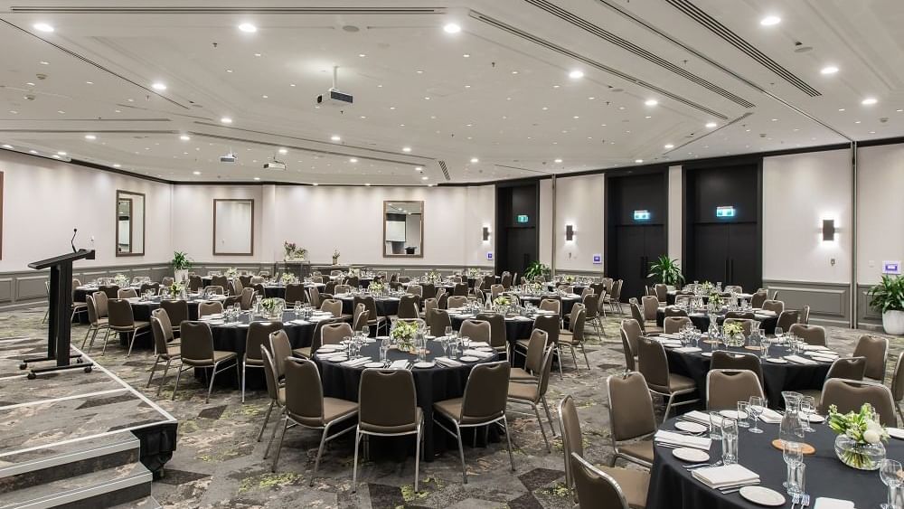 Grand Ballroom with stage and set up banquets at Novotel Sydney International Airport