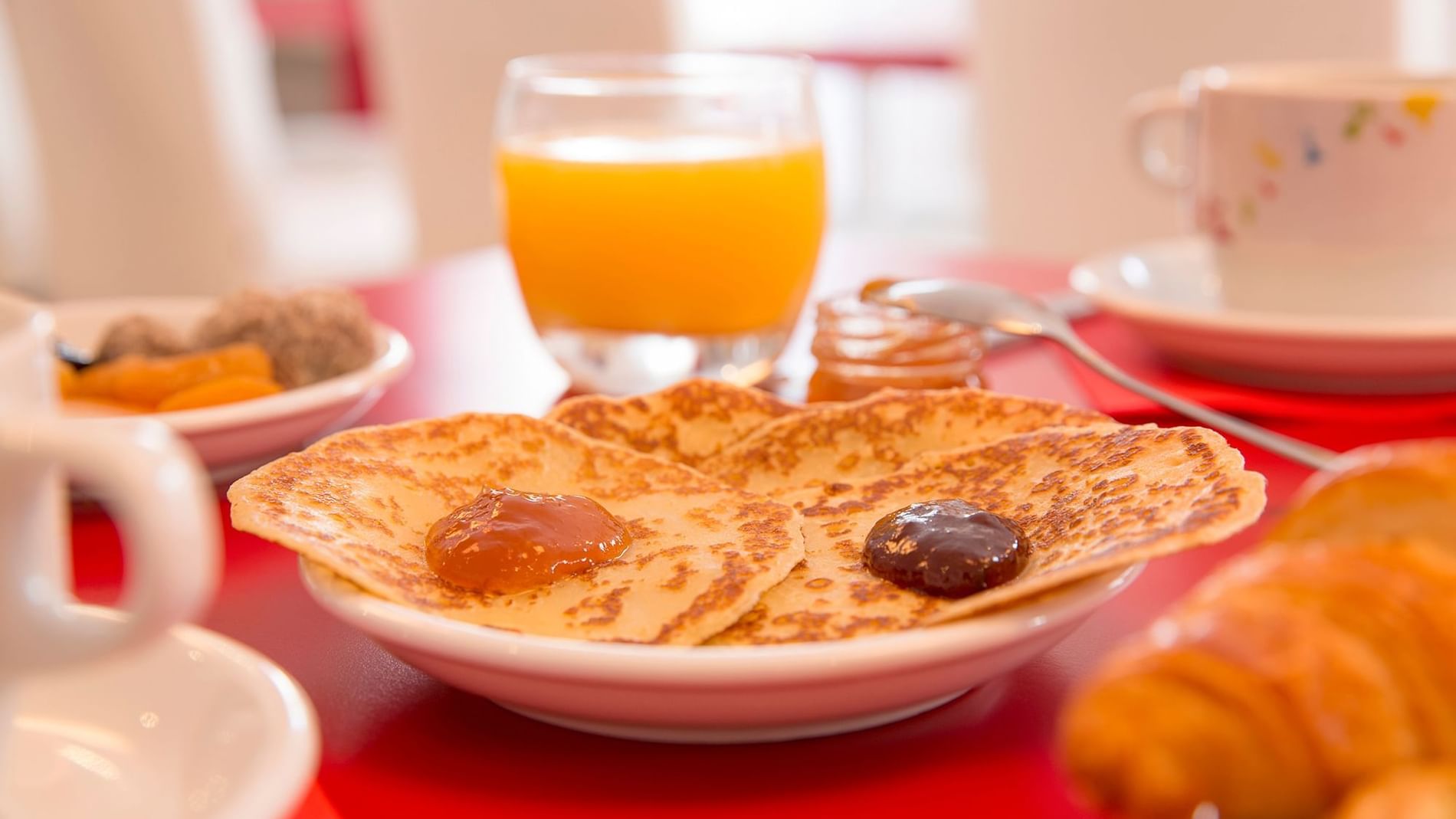 Closeup of pancakes & juice served at Originals Hotels