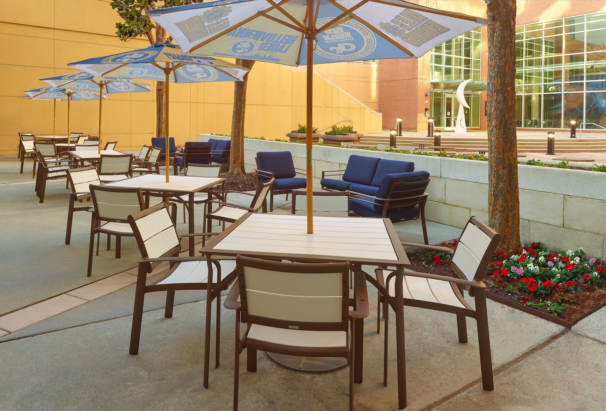 A patio area with outdoor seating and umbrellas