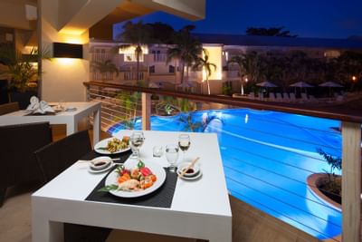 A dining table with pool view in Umi Restaurant at Sugar Bay