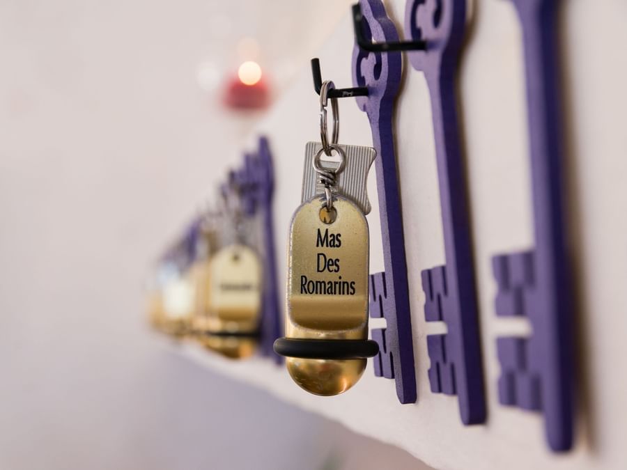 Room keys hanging on the wall at reception of Mas des Romarins