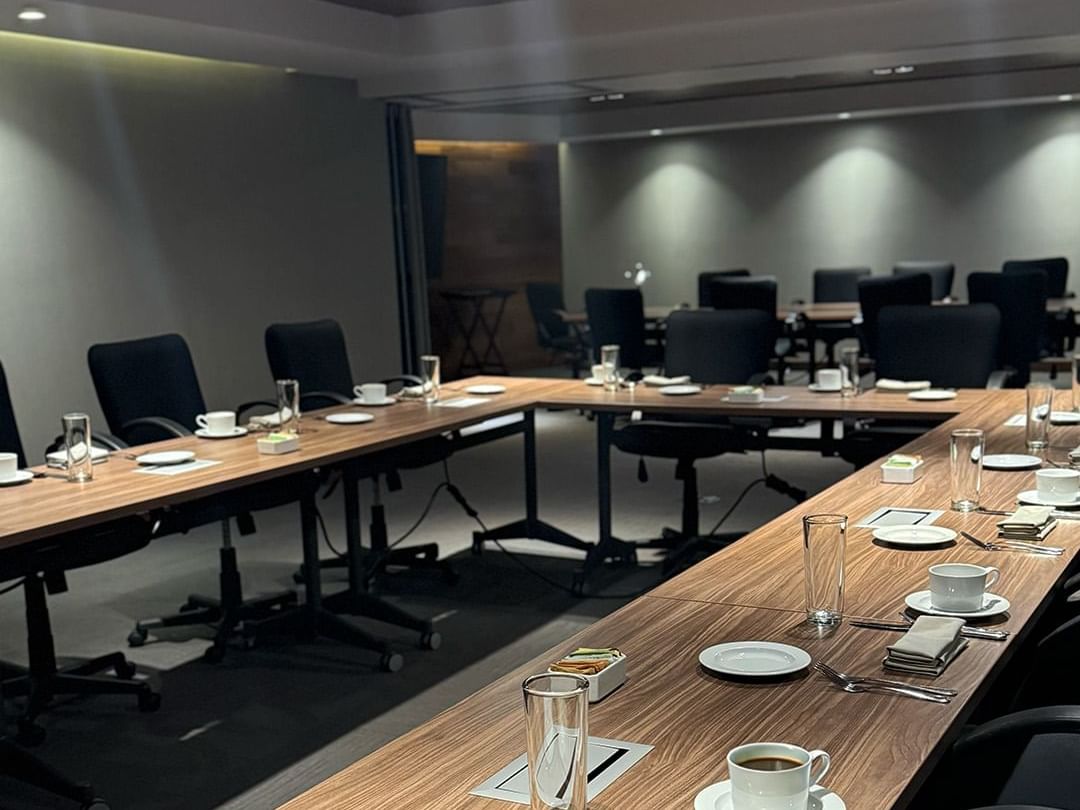 U-shaped conference table set in Meeting Rooms C plus D with plates, cups, and utensils at Fiesta Americana San Luis Potosi